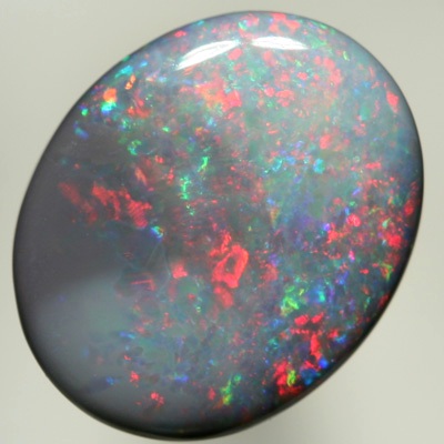 SOLID SEMI BLACK OPAL Red sparkles move over green and purple